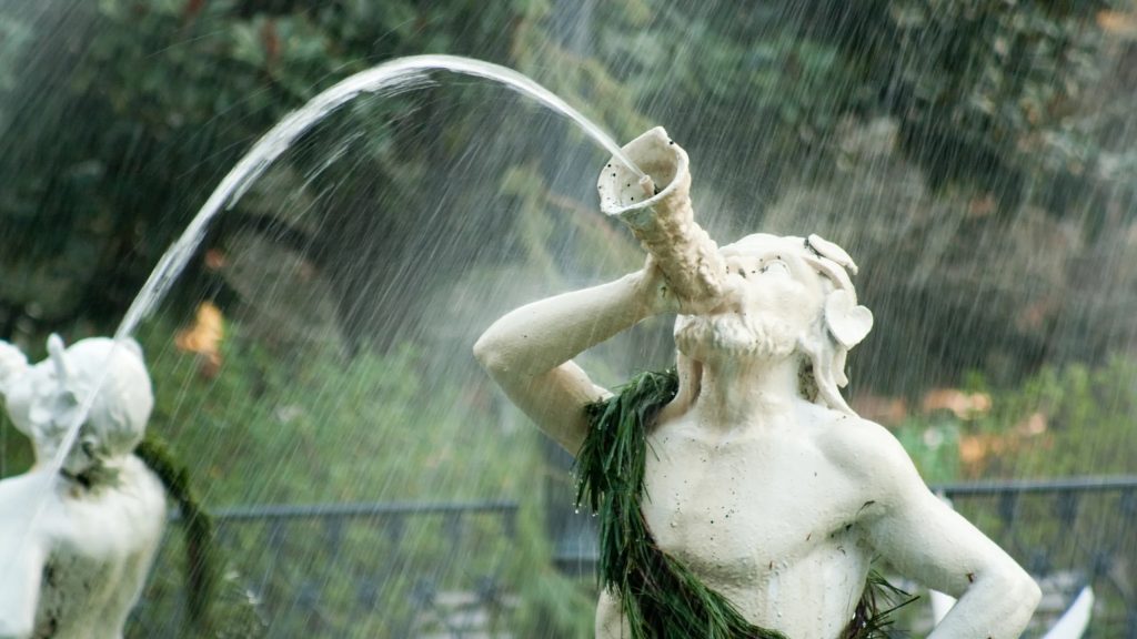Fountain figure statue spraying water in a Savannah garden